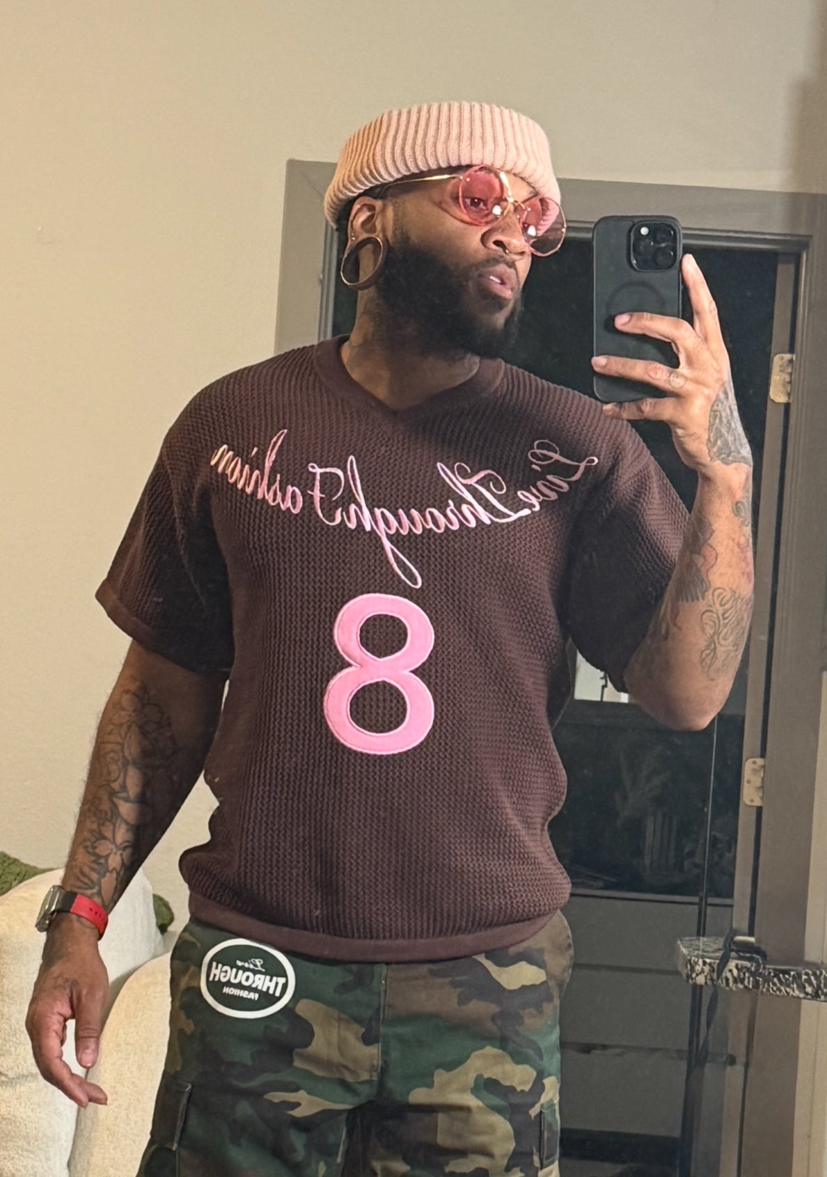Short sleeve knit v-neck sweater in deep chocolate brown with pink logo ￼ embroidered with lucky number 8      The number 8 symbolizes infinity,   balance, and abundance, stemming from its infinite shape.